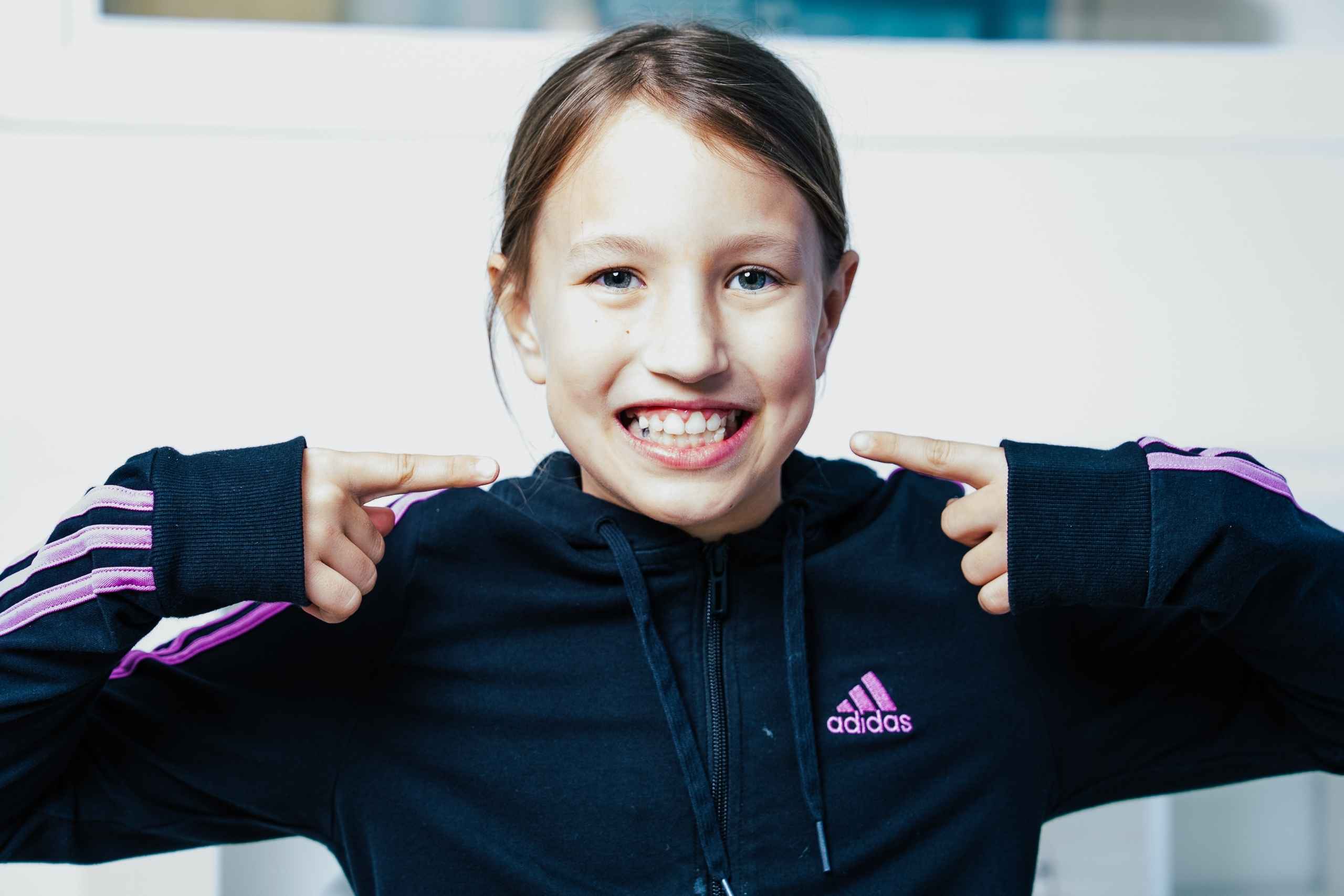 Smiling child with braces at an orthodontic clinic after a fitting appointment