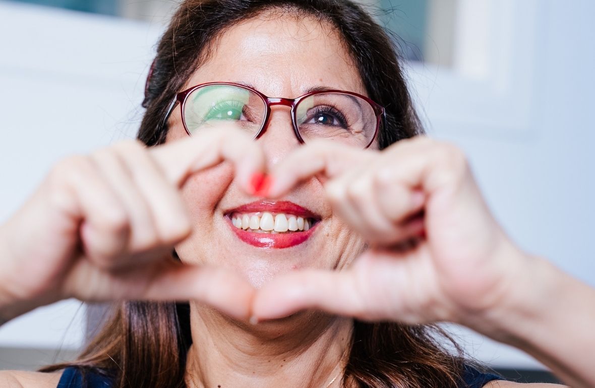 Adult patient in a dental chair discussing a clear aligner treatment plan