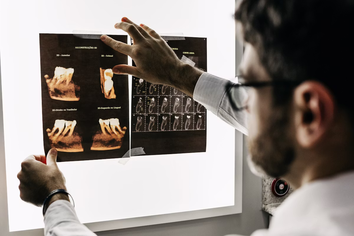 Orthodontist in Abu Dhabi reviewing a patient's bite alignment during a consultation